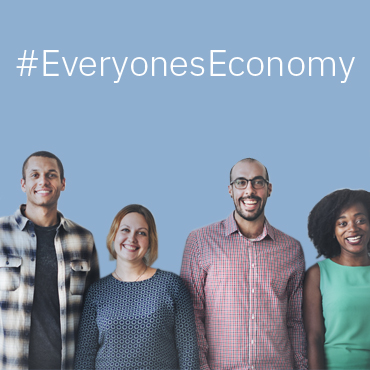 photograph of a line of smiling people, with the tagline "Everyone's Economy"