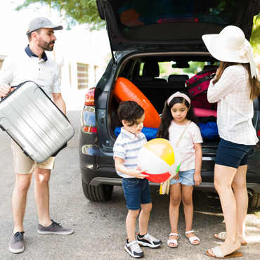 family packs car for vacation