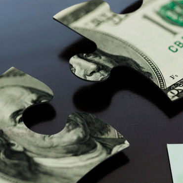 puzzle pieces, not quite joined, in the form of dollar bill